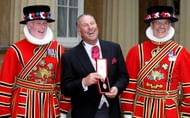 England and Somerset cricket legend Sir Ian Botham (C) poses with two Yeoman of the Guard after he received his knighthood from the Queen at Buckingham Palace, in London, 10 October 2007.